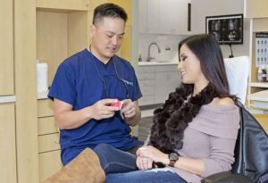 dentist discussing dental implants san ramon treatment plan with patient in dental clinic
