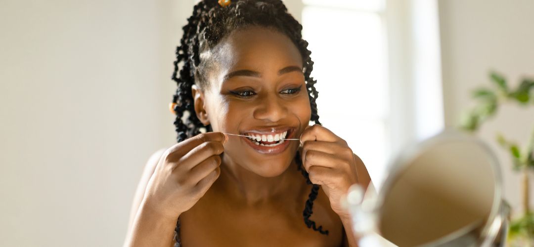 Woman flossing her teeth