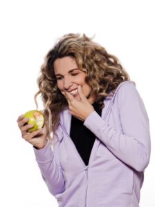 Woman Who Bit Into An Apple And Has Bleeding Gums.