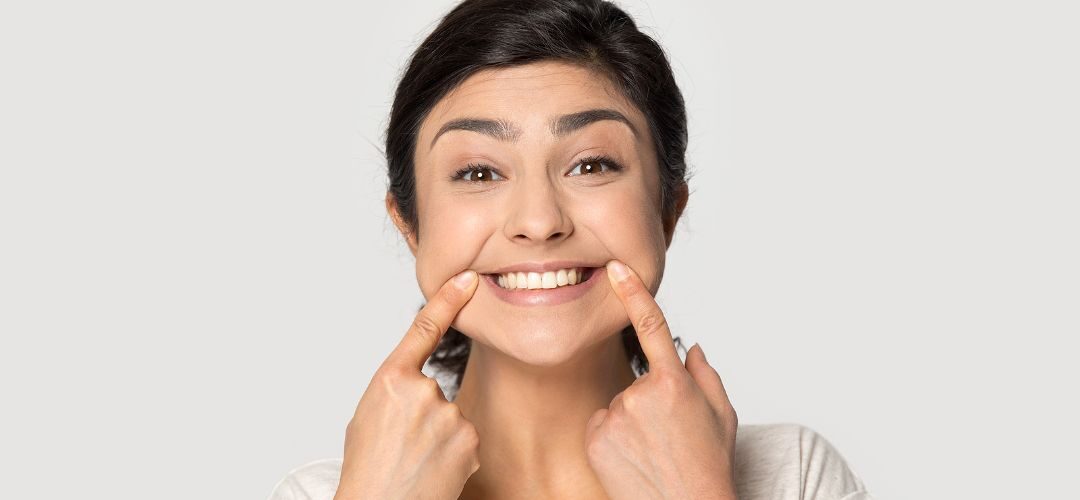 A person showing off their teeth whitening with a smile